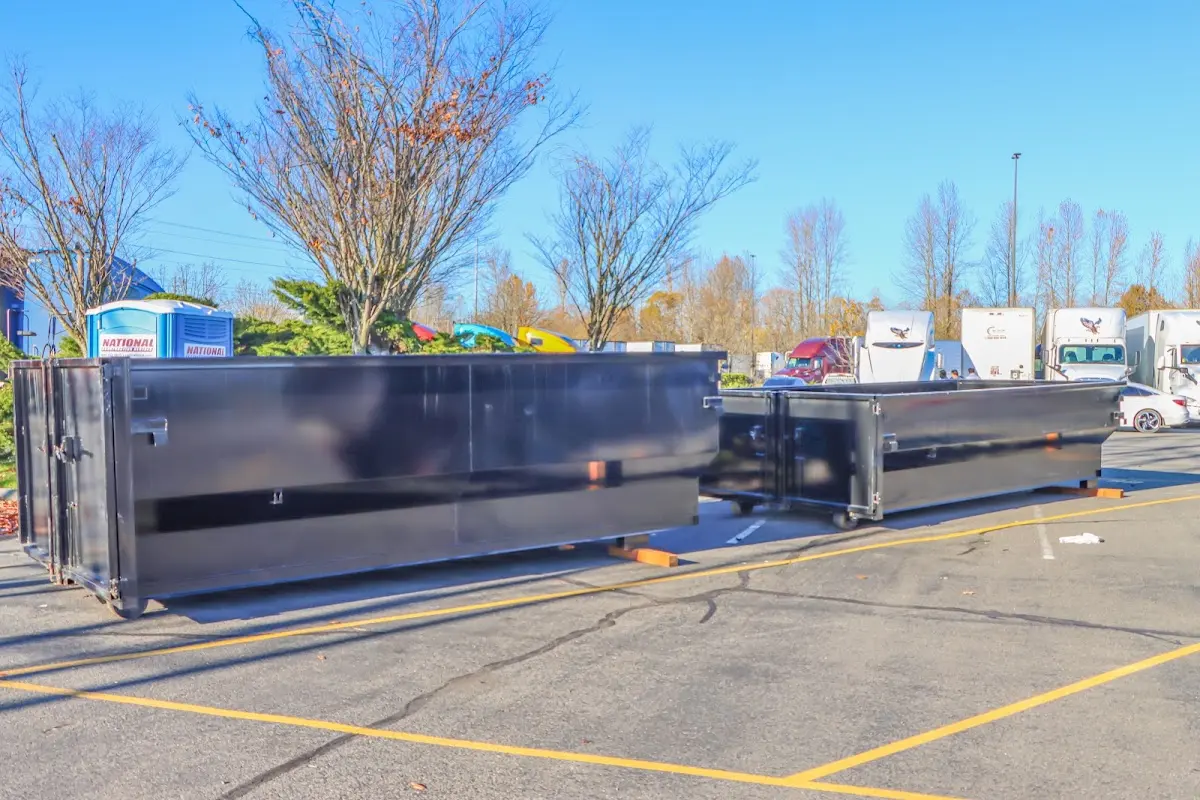 Professional dumpster rental service with roll-off container on residential driveway in Lewisville